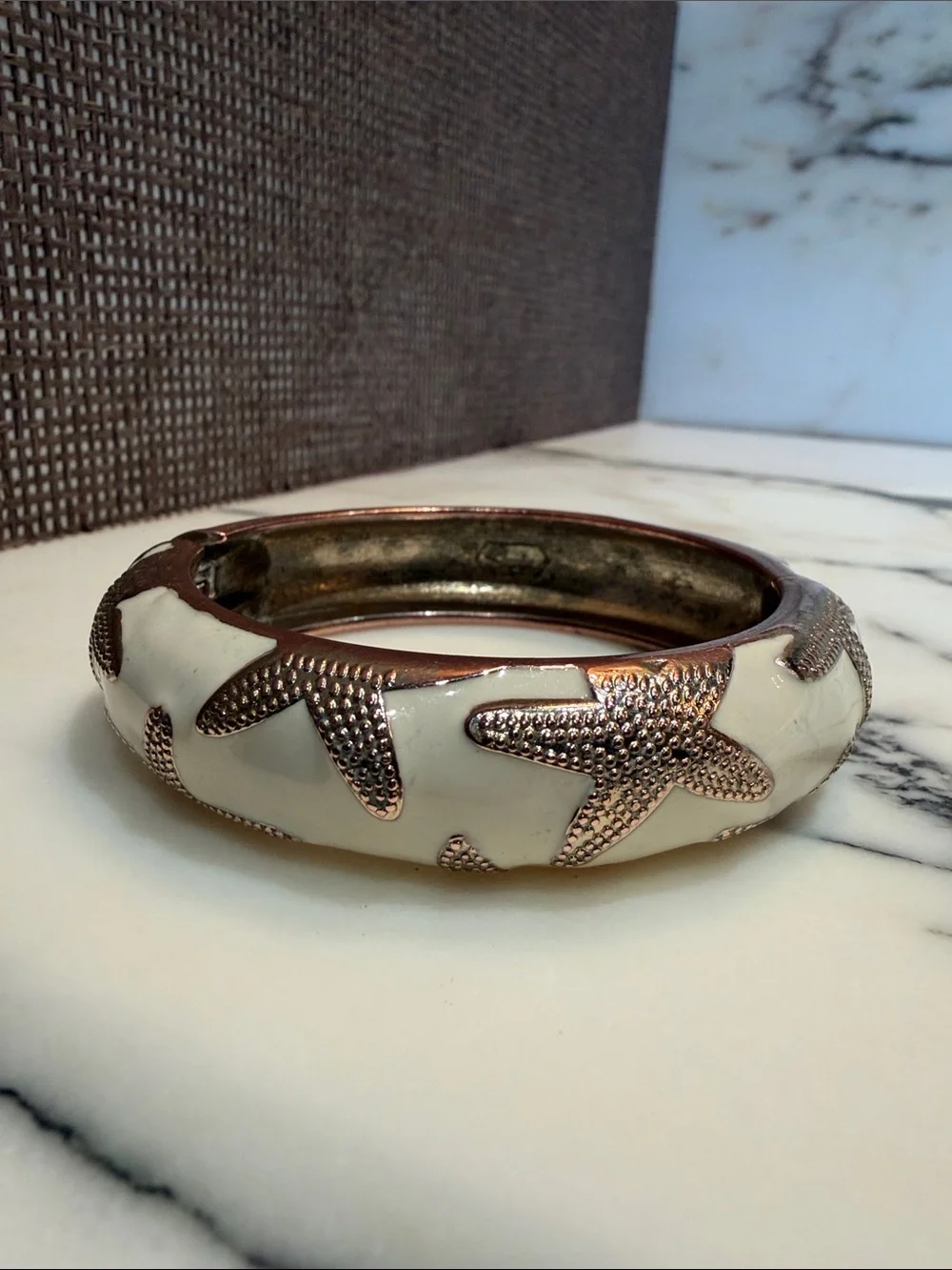White enamel Bangle Bracelet with Textured gold tone Starfish Accents